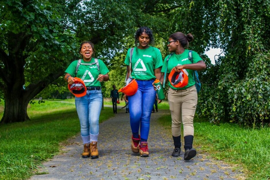 group of three girls laughing in a park